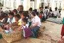 Children stand in line for getting rice as their lunch meal.jpg