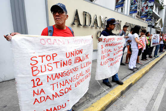 Workers decry dismissal from Catholic university in Manila