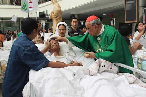 Retired Indonesian Jesuit Cardinal Julius Riyadi Darmaatmadja anoints a patient at St. Elisabeth Hospital in Semarang, Central Java on Feb.12, on World of Day of the Sick