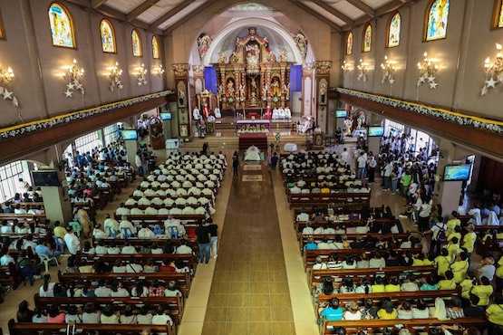 Huge crowd of mourners bid farewell to slain priest