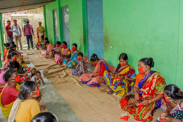 Indigenous women make masks for poor Bangladeshi villagers