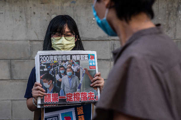 Hong Kong daily vows to fight for democracy after owner's arrest