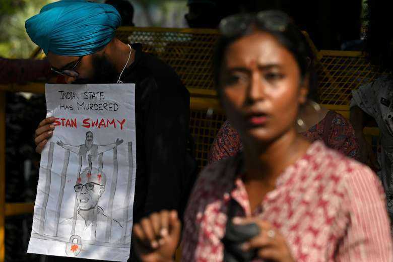 Indian students take part in a protest in New Delhi on July 6 after Father Stan Swamy, who was detained for nine months without trial under anti-terrorism laws, died on July 5 ahead of a bail hearing