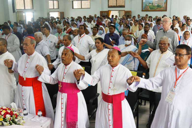Catholic clergy, religious and laypeople join hands to pray during the 50th anniversary program of the Catholic Bishops' Conference of Bangladesh in capital Dhaka on May 27