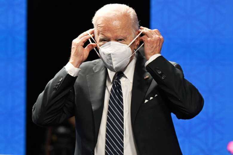 US President Joe Biden adjusts his mask as he attends the Indo-Pacific Economic Framework for Prosperity at the Izumi Garden Gallery in Tokyo on May 23