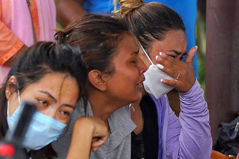 Family members and relatives of passengers on board the Twin Otter aircraft operated by Tara Air weep outside the airport in Pokhara on May 29