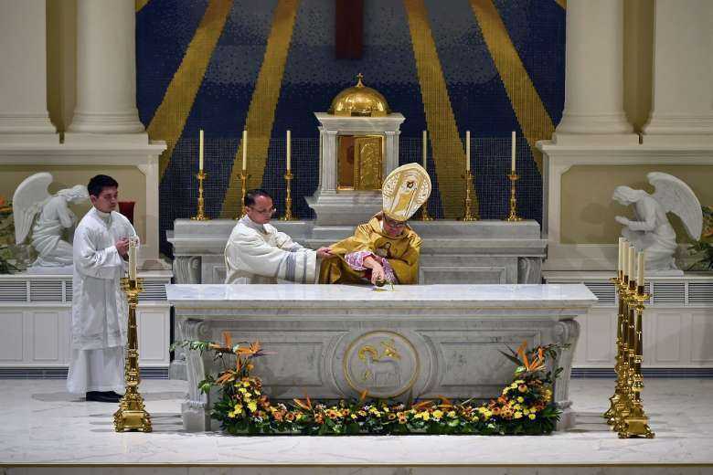 Archbishop William Goh performs the Rite of Dedication marking the 120th anniversary of the Cathedral of the Good Shepherd in Singapore on Feb. 14, 2017