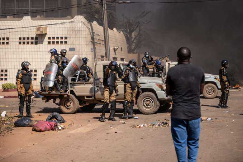 Protestors face security forces firing tear gas during a demonstration in Ouagadougou, the capital of Burkina Faso, on Nov. 27, 2021