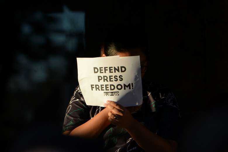 A student holds a placard during a protest at the state university grounds in Manila on Feb. 14, 2019, in support of Rappler CEO Maria Ressa, who was arrested a day earlier in a cyber libel case. Ressa was later convicted in a case that sparked international censure and allegations she had been targeted over her news site's criticism of President Rodrigo Duterte