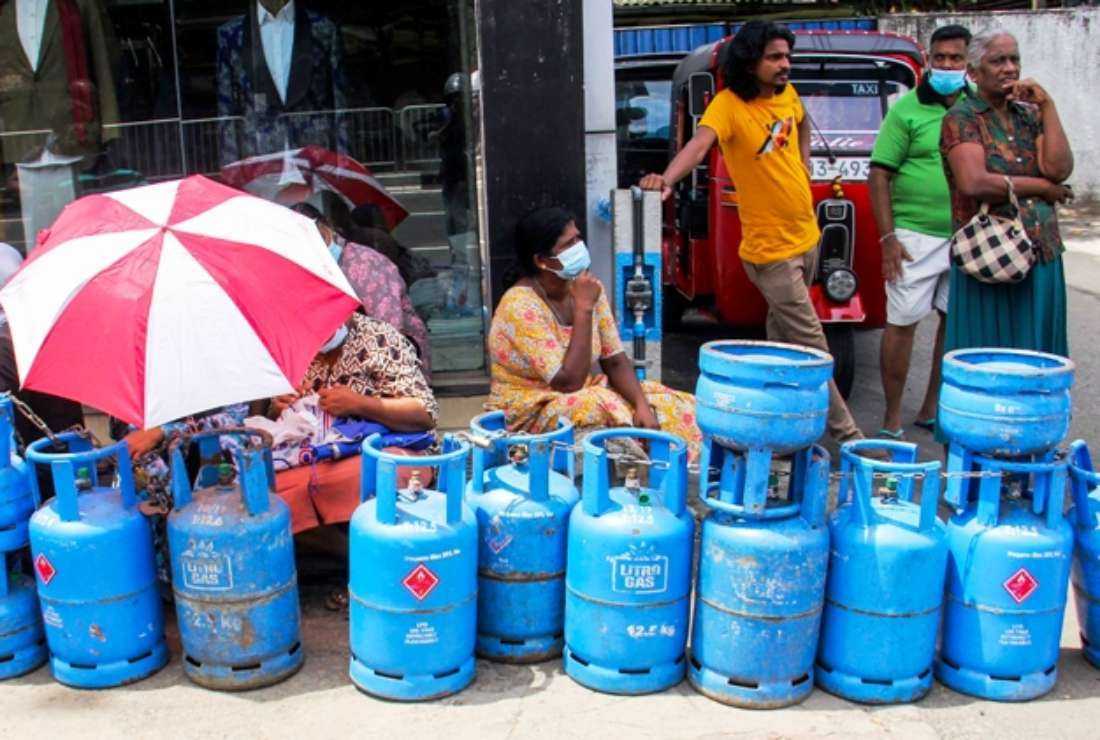 Sri Lankan people wait in a long queue to refill their liquefied petroleum gas (LPG) cylinders in Colombo on June 15