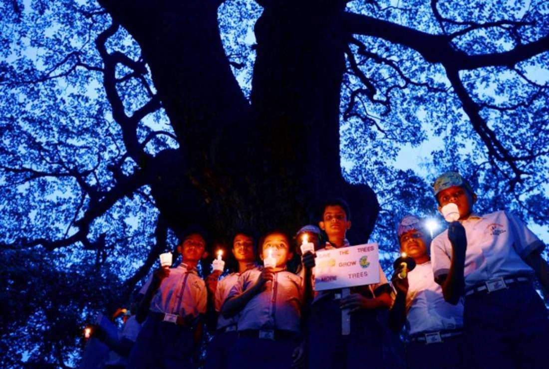 Indian children take part in a candlelit vigil held as part of a 'Save Trees' awareness rally in Bangalore on June 7, 2017