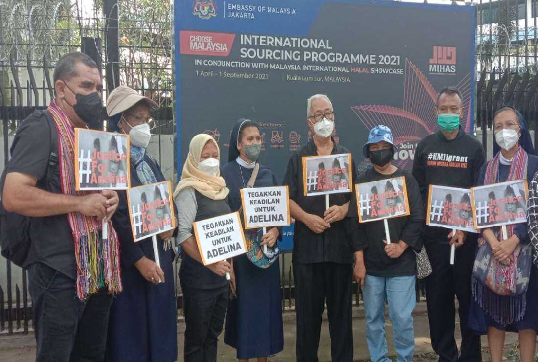 Jesuit Father Ignatius Ismartono (fourth from right, wearing a white face mask) joins nuns and anti-human trafficking activists in a protest held on June 27 in Jakarta to demand justice for Adelina Jemira Sau, an Indonesian maid who died in Malaysia four years ago