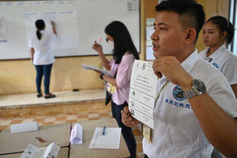 Cambodian election officials count ballots at a polling station during the commune election in Phnom Penh on June 5