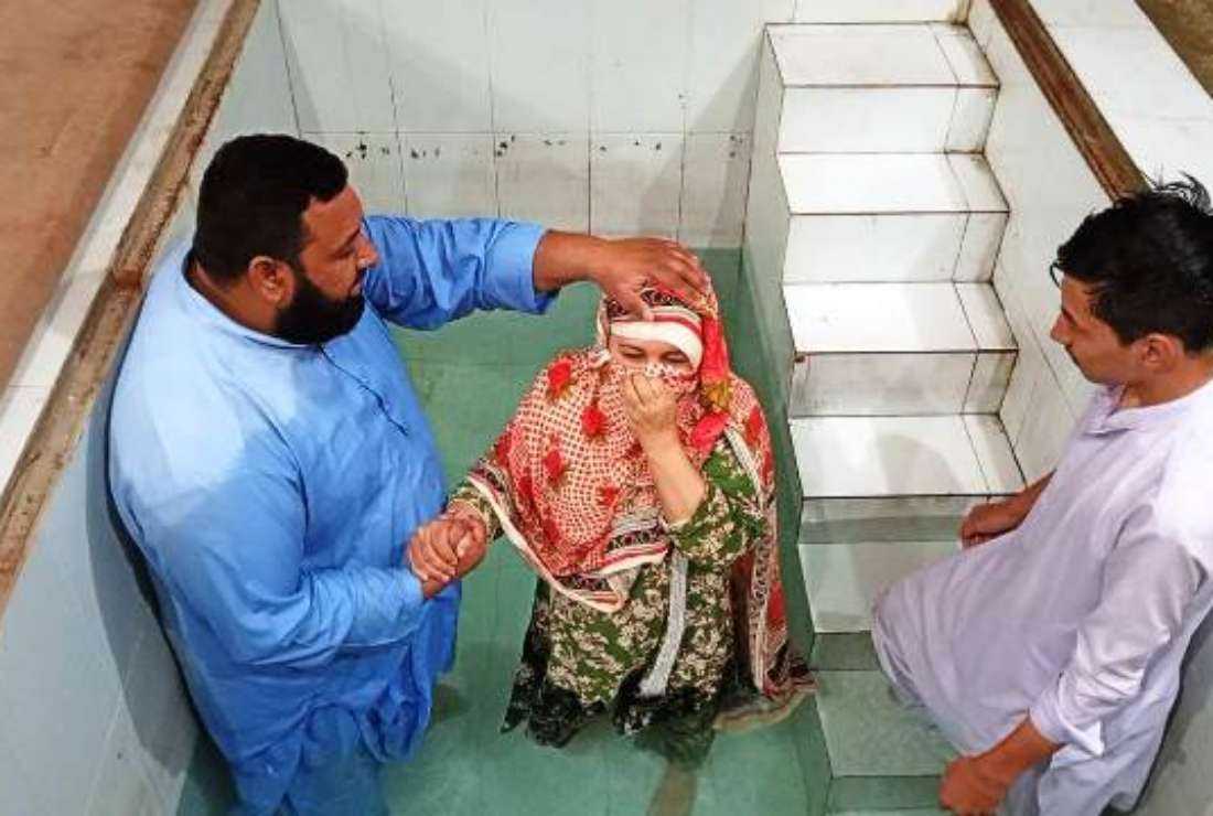 Pastor Irfan James baptizes an Afghan refugee in Quetta