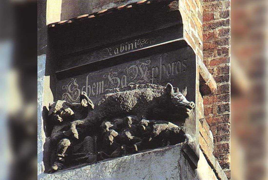 The 13th-century 'Judensau' carving on the wall of Wittenberg Stadtkirche