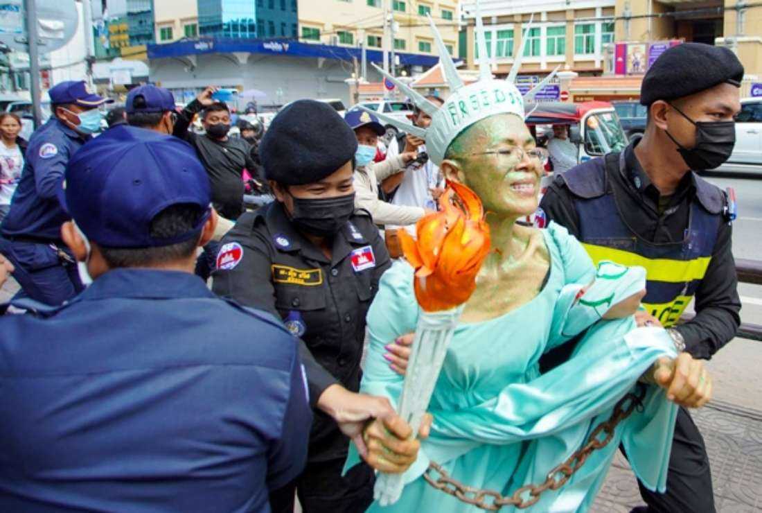 Cambodian-US human rights advocate Theary Seng, dressed as Lady Liberty, is arrested by police after being found guilty of treason in her trial in front of Phnom Penh Municipal Court on June 14