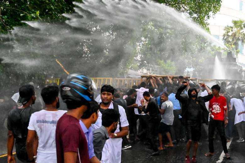 Police use a water cannon to disperse students during an anti-government protest demanding the resignation of President Gotabaya Rajapaksa over the crippling economic crisis in Colombo on May 29