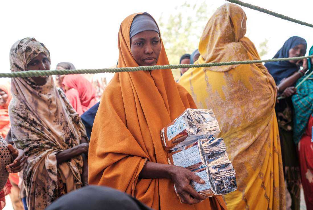 An internally displaced woman holds nutrition packs during a food distribution organised by the World Food Program (WFP) in the village of Adlale, near the city of Gode, Ethiopia, on April 6