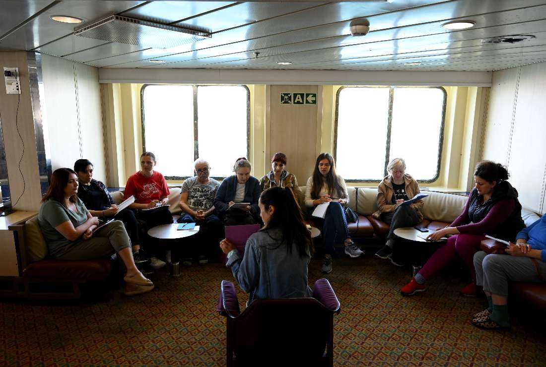 Ukrainian people attend a French lesson aboard the Corsica Linea ferry Mediterranee in Marseille, southern France, on April 26