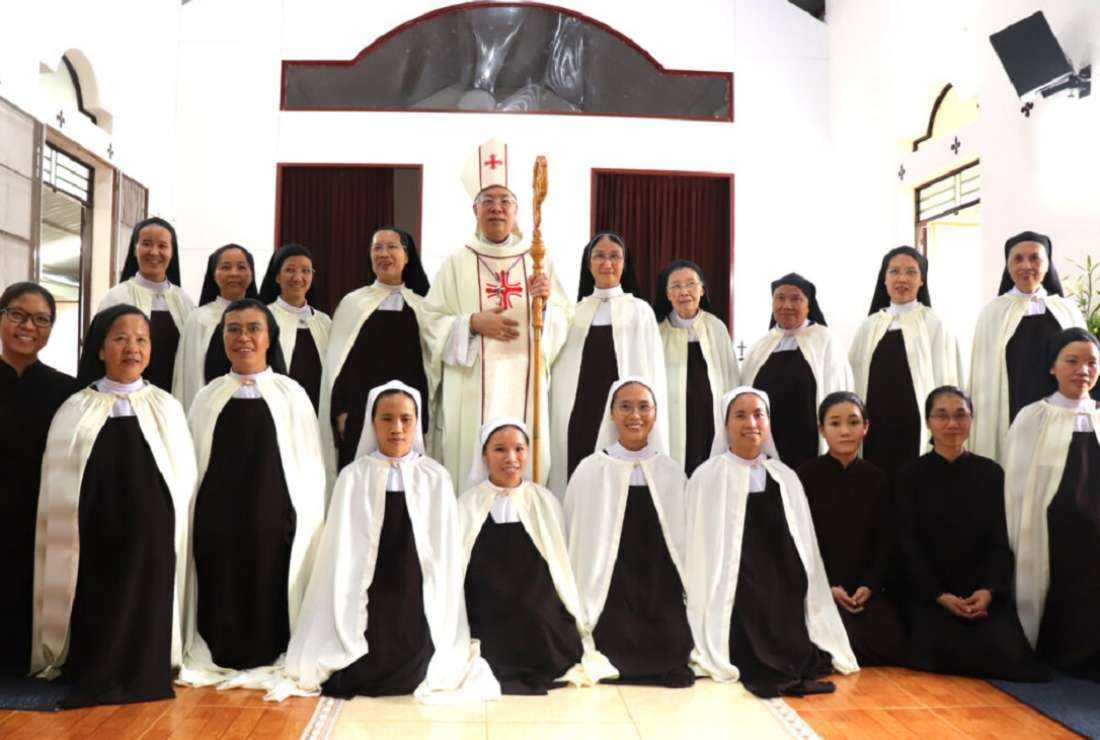 Bishop Aloisius Nguyen Hung Vi of Kontum and Discalced Carmelite nuns pose for a photo on June 7