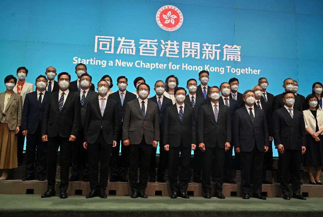 Hong Kong's chief executive-elect John Lee (front center) with his newly appointed cabinet at the central government's headquarters in Hong Kong on June 19