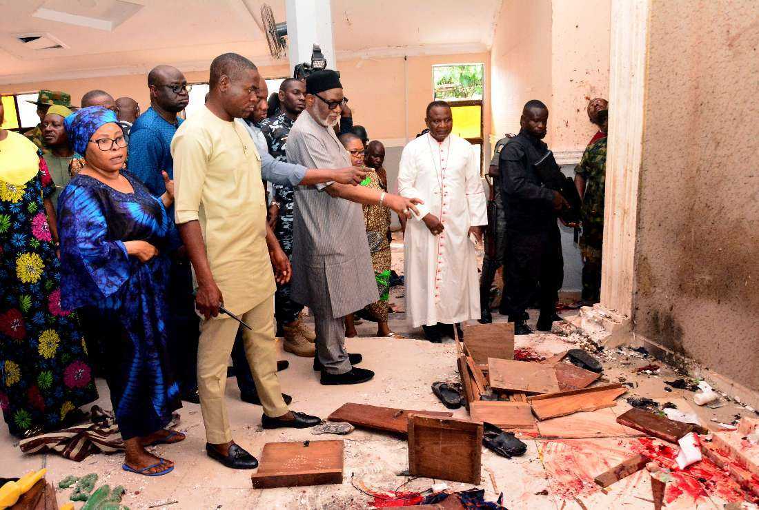 Ondo State governor Rotimi Akeredolu points to blood on the floor after an attack by gunmen at St. Francis Catholic Church in Owo town, southwest Nigeria, on June 5