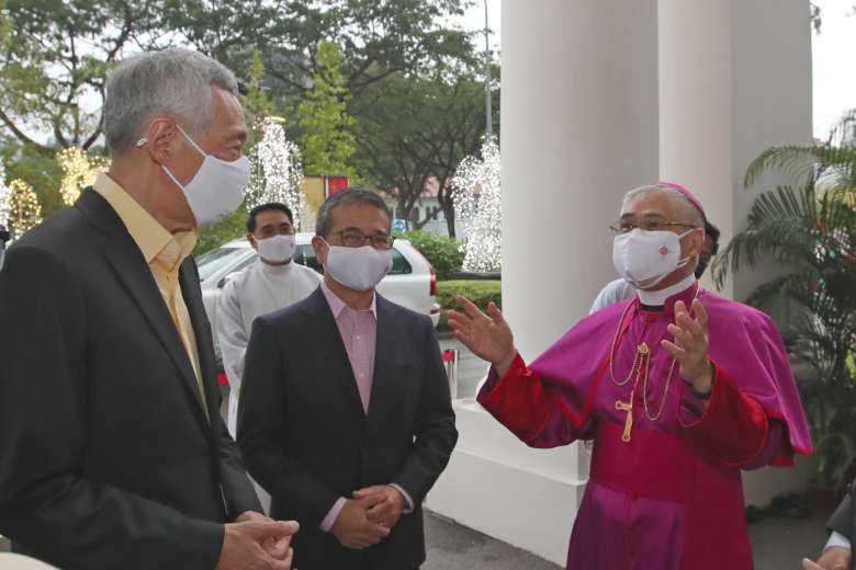 Singapore's Prime Minister Lee Hsien Loong (left) is seen with Archbishop William Goh at the Cathedral of the Good Shepherd in December 2021 to mark the bicentennial of the local church