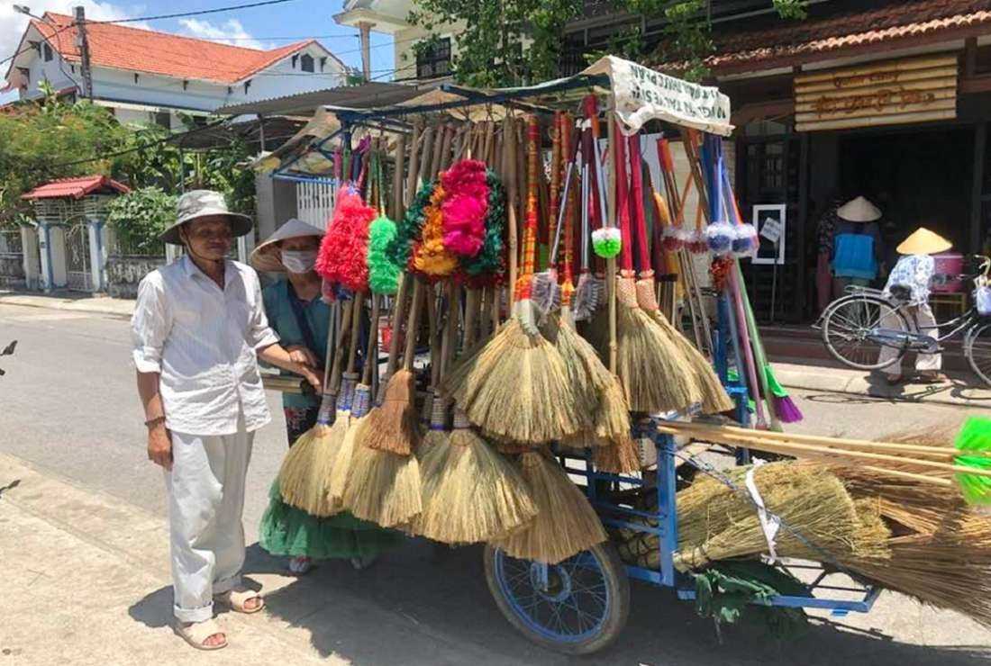 Former soldier Joseph Le Duy Hien and his wife sell straw brooms for a living in a street in Dong Ha