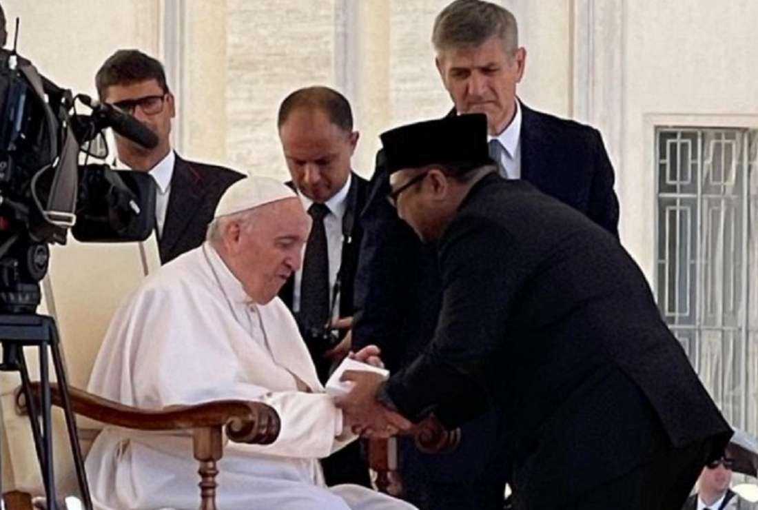 Indonesia’s Religious Affairs Minister Yaqut Cholil Qoumas shakes Pope Francis’ hand at the Vatican on June 8