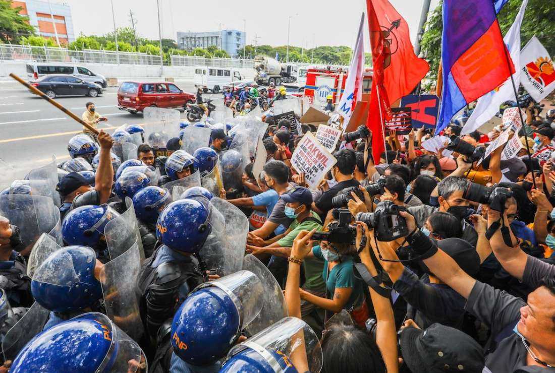 Protesters clash with police officers outside the Commission of Human Rights to denounce the 2022 election results in Quezon City, suburban Manila, on May 25