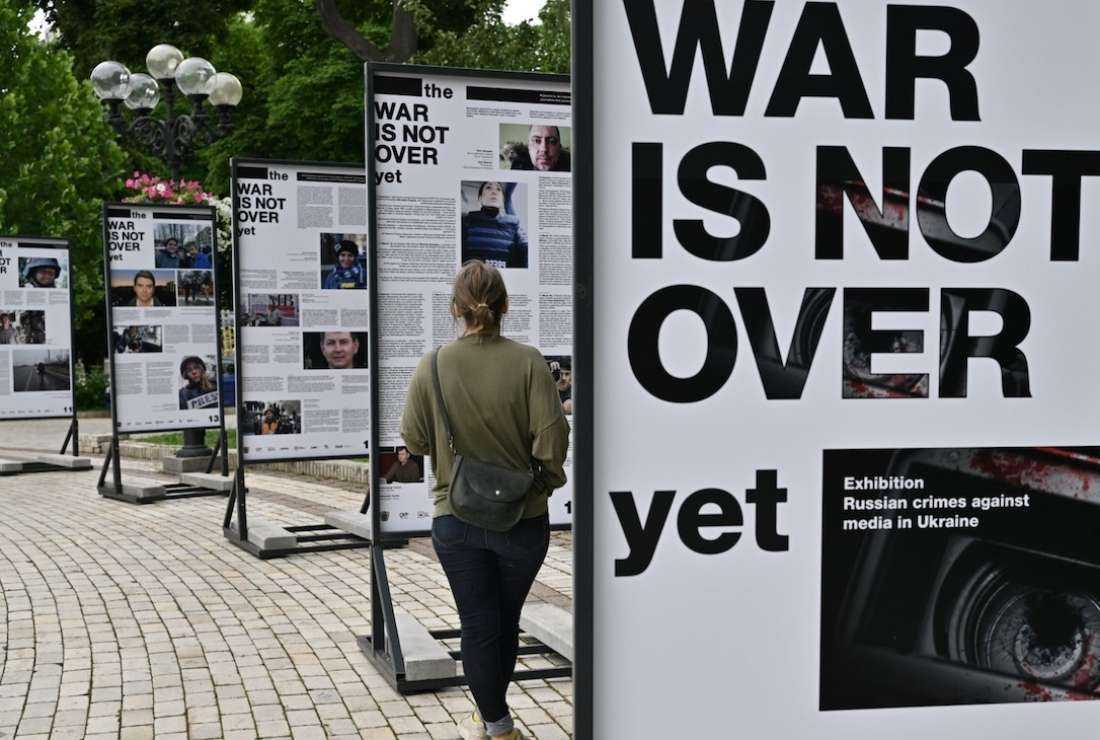 A woman visits the 'The war is not over' photo exhibition opened in Taras Shevchenko Park in Kyiv on June 23 amid Russia's invasion of Ukraine