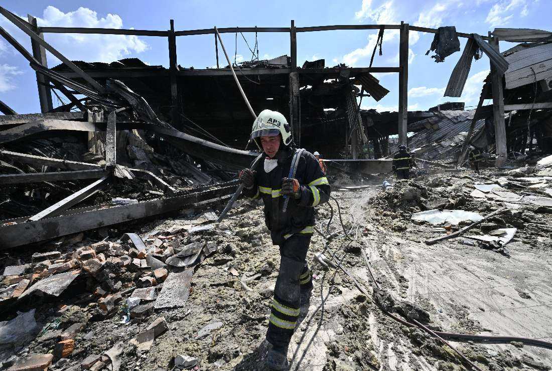 Rescuers clear rubbles of the Amstor mall in Kremenchuk, a day after it was hit by a Russian missile strike, on June 28