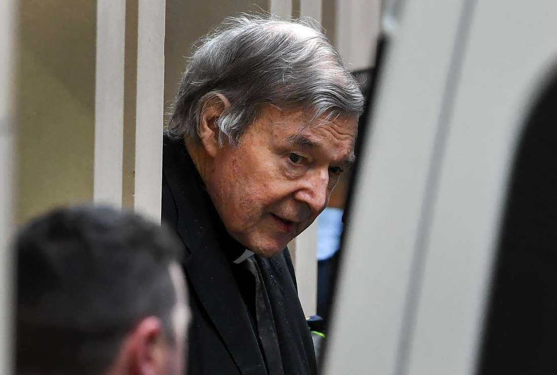 Australian Cardinal George Pell is escorted in handcuffs from the Supreme Court of Victoria in Melbourne on Aug. 21, 2019