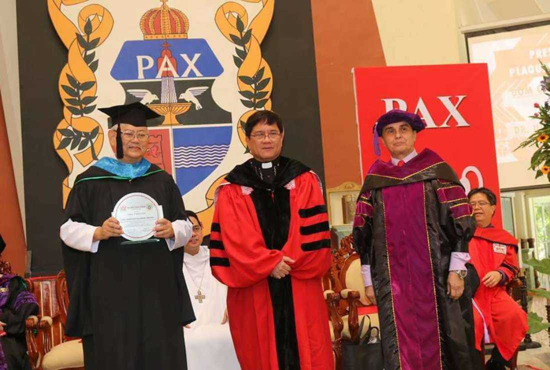 Father Ranhilio Aquino (center) is seen during a graduation ceremony at San Beda University