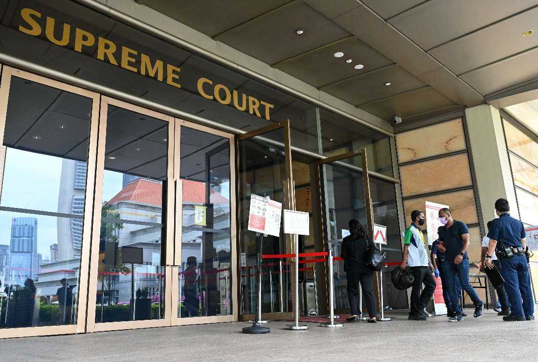 People enter the Supreme Court in Singapore as the city state's top court hears a last-ditch appeal of a Malaysian man facing execution over drug trafficking charges despite concerns he is mentally disabled, on March 1