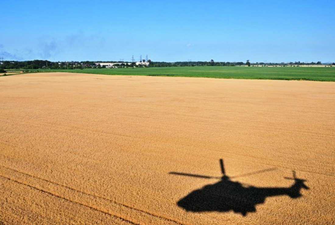 The shadow of a helicopter is seen on the field of wheat in Kyiv region amid the Russian invasion of Ukraine on July 14