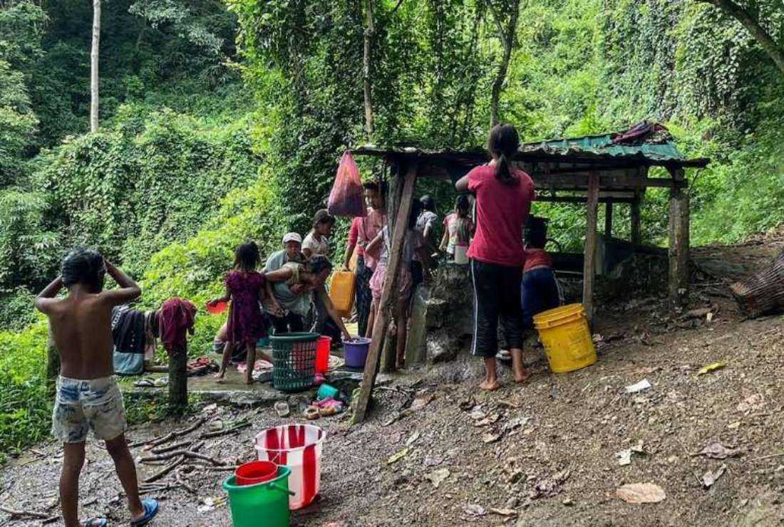 Myanmar refugees collect water at Pang village in India's eastern state of Mizoram on Sept. 24, 2021