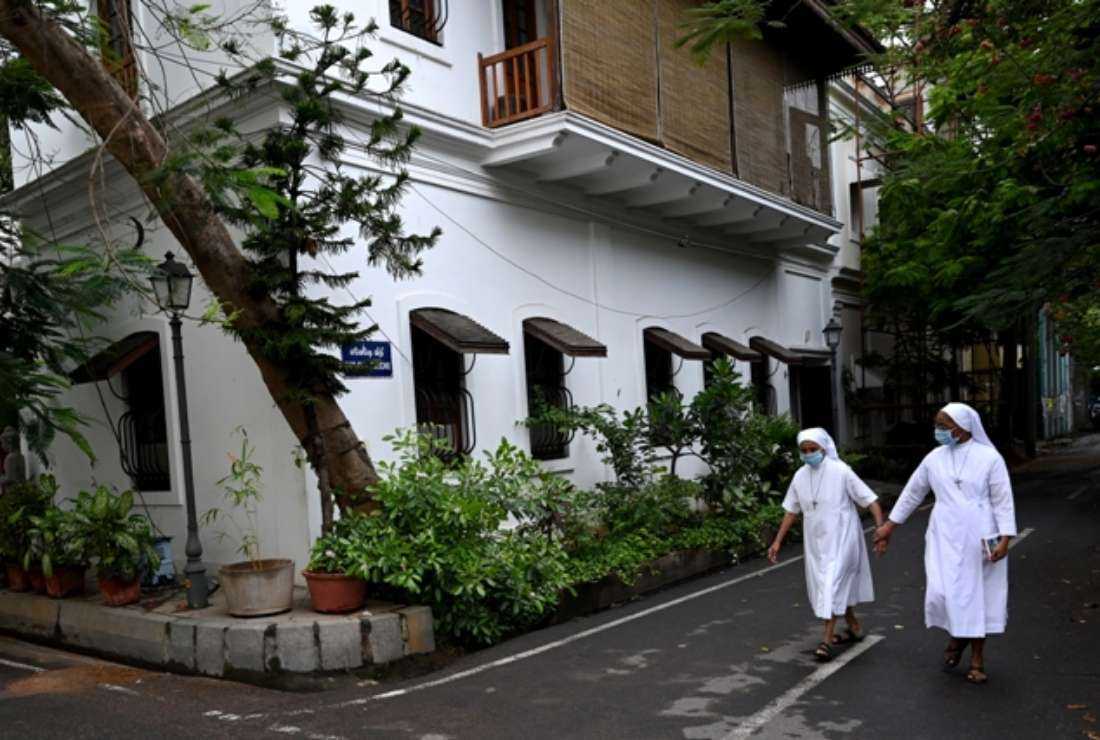 Catholic nuns walk the streets of White Town in Pondicherry on April 10