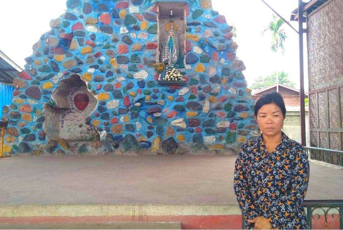Ji Grawng is seen before a make-shift house in the St.Paul's Ja Mai Kaung IDP camp run by the Catholic Church on the outskirts of Myitkyina, Kachin state's capital city