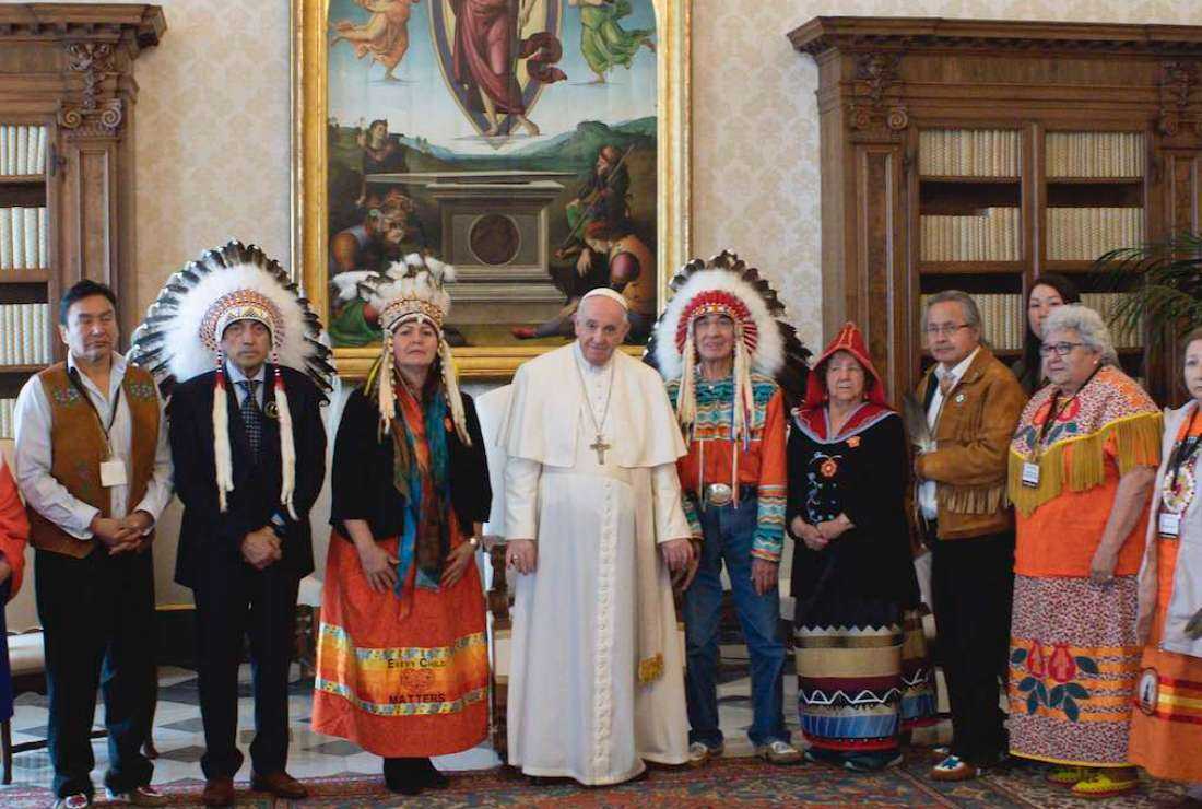 This photo, taken on March 31, 2022 and handed out on April 1, 2022 by The Vatican Media, shows Pope Francis, center, posing with First Nations delegation members at the Vatican, during a series of week-long meetings of Canada's Indigenous elders, leaders, survivors and youth at the Vatican