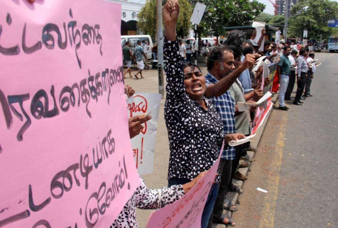 Sri Lankans shout slogans during a protest in front of the Fort Railway Station in Colombo on July 27 amid worries over the growing repression of public dissent across the nation.