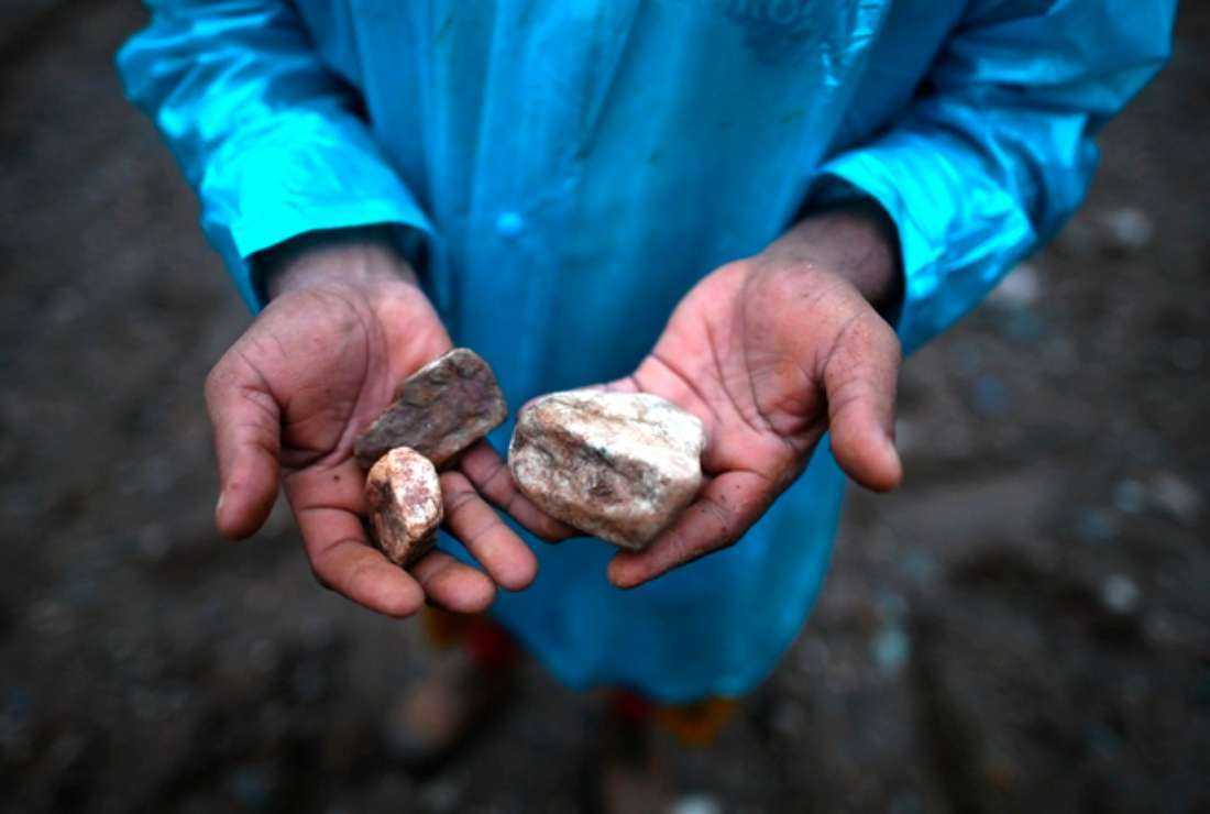 A miner shows jade at a mine near Hpakant in Kachin state, Myanmar, on July 4, 2020
