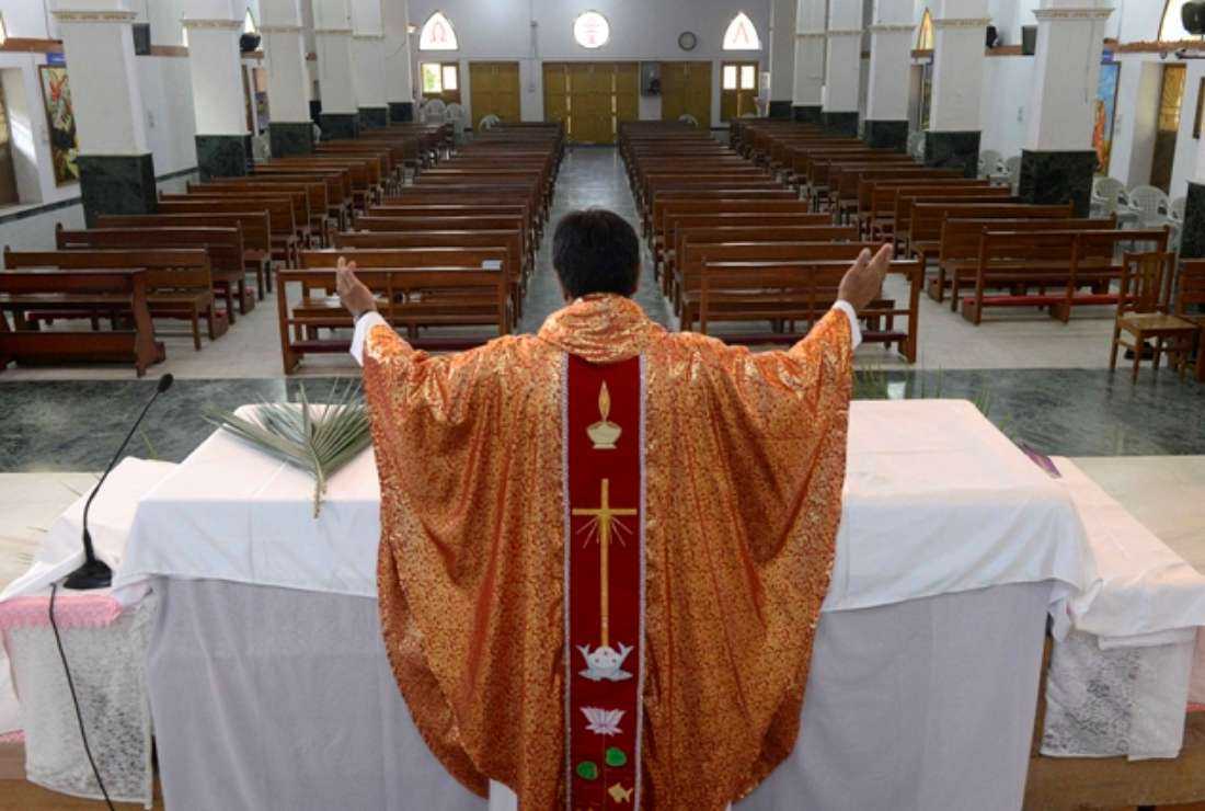 An Indian Catholic priest celebrates a private mass on a Palm Sunday event during the nationwide lockdown as a preventive measure against coronavirus in Secunderabad city, on April 5, 2020