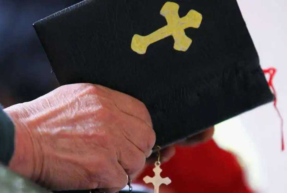 A Christian man holding a Bible