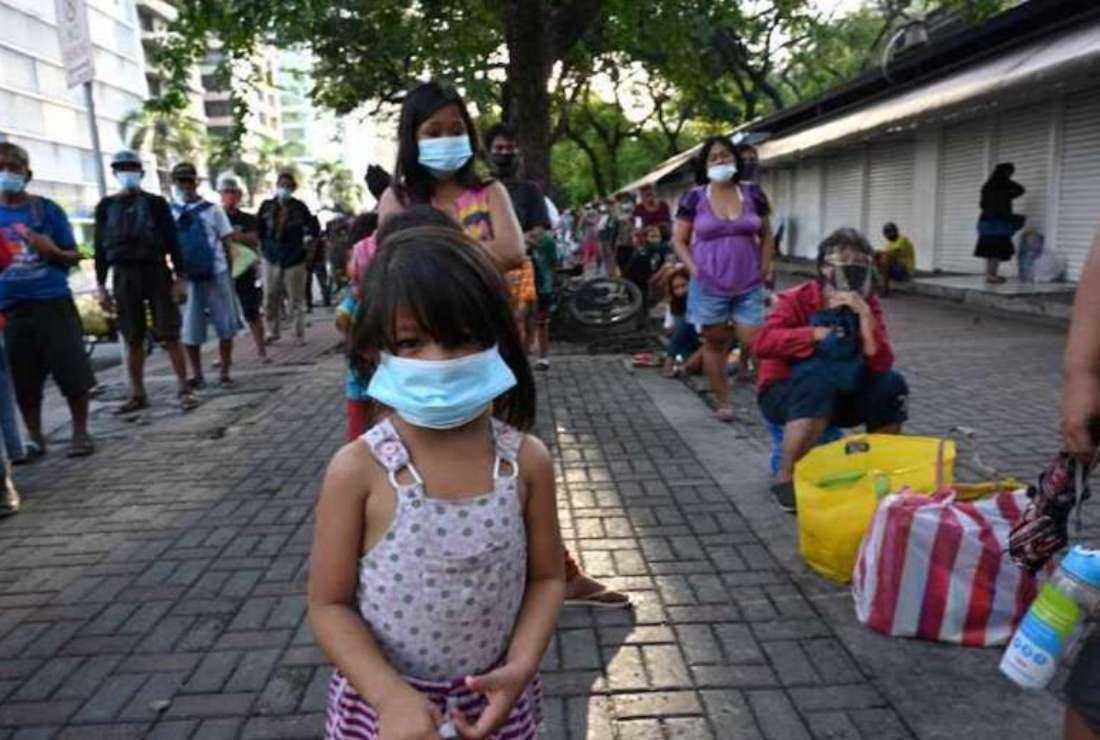Street dwellers including children queue for free food distributed by the Society of the Divine Word in Manila. The pandemic has brought an increase in the sexual abuse of children in the Philippines