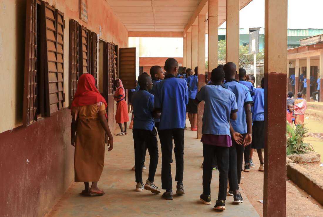 Pupils of Tsinga Bilingual High School walk around the schoolyard during break time in Yaounde on March 16, 2022