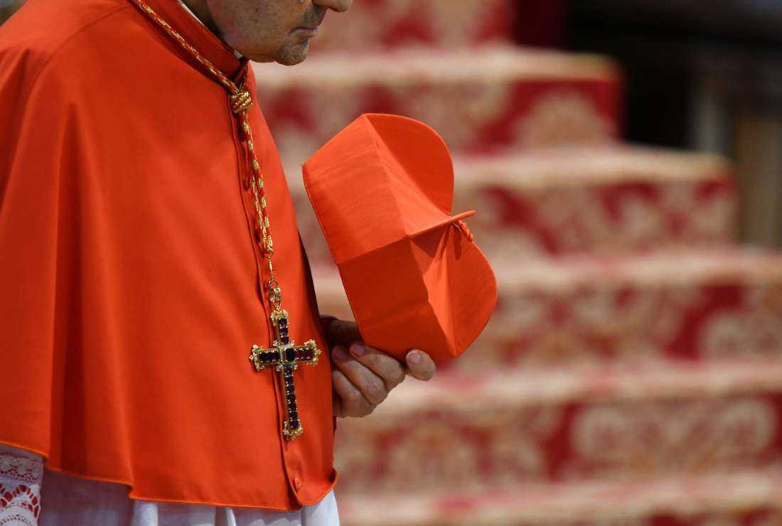 A cardinal holds his red three-cornered biretta hat before the start of a consistory for the creation of five new cardinals, at St Peter's Basilica in the Vatican on June 28, 2017