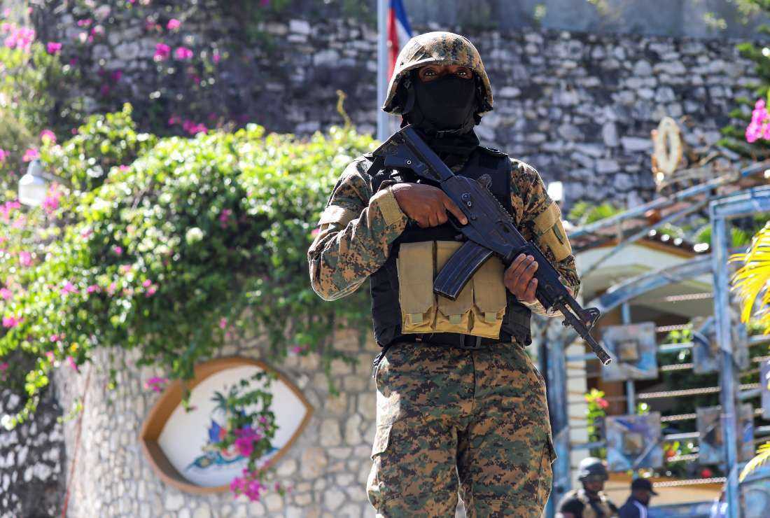 A Haitian police officer stands guard outside of the presidential residence in Port-au-Prince, on July 7, 2021.