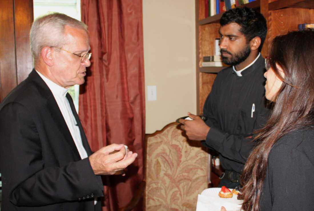 Monsignor Peter I. Vaccari (left) speaks with Father Joby Joseph of the Syro-Malabar Church and Leah Bromberg of the Lumen Christi Institute at a gathering of Eastern Christian leaders in the Chicago area on July 19