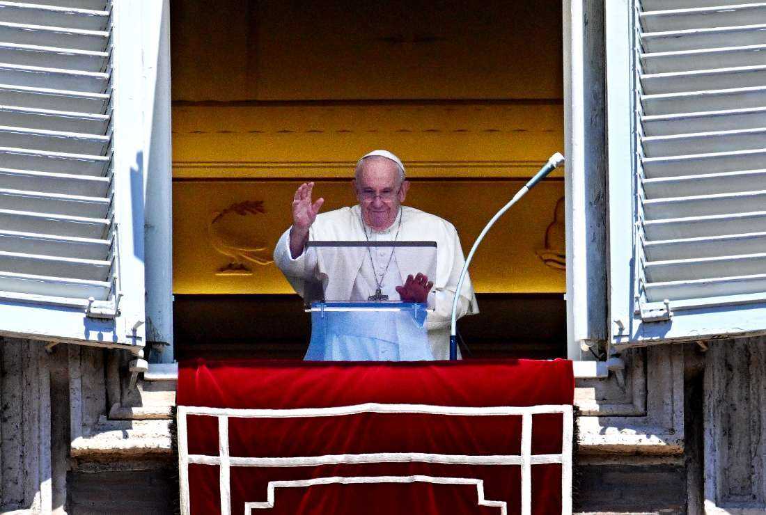 Pope Francis waves as he addresses the crowd during his Angelus prayer from the window of the apostolic palace overlooking St. Peter's Square, at the Vatican, on July 31